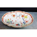 An oval porcelain dish with scalloped gilt edged rim painted with chrysanthemums, birds and foliage,