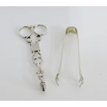 A pair of 19th century scissor action sugar nips together with a pair of Sheffield silver claw sugar