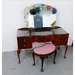 A mahogany dressing table, with an arrangement of five drawers, raised on cabriole supports together