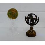 A small reproduction pocket globe, together with a small modern Zodiac globe on a turned wood