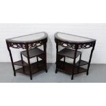 A pair of Chinese style side tables, each with demi lune marble tops over carved pierced frieze
