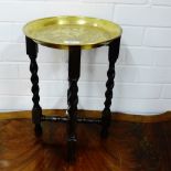 A small brass top Benares style table with Pagoda pattern