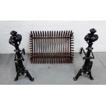 A pair of black wrought iron Gothic Revival fire irons and grate (2)