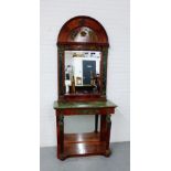 A French Empire style mahogany console table and pier mirror with a domed top detailed with gilt