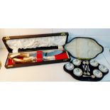 A cased set of six Epns salts together with a horn handled and Sheffield steel blade carving set,