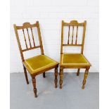 A pair of mahogany spindle back side chairs with upholstered seats and turned supports (2) 90 x