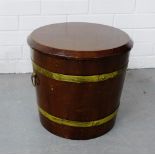 A mahogany and brass bound barrel and cover, with ring handles to side, 34 x 36cm