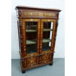 A 19th century rosewood and ivory inlaid display cabinet, the foliate carved cornice top over a pair