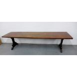 A 19th century oak 10ft trencher table, the rectangular top with moulded edge, raised on shaped side