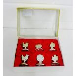 A set of six sterling silver Chinese motif menu/place name holders, stamped sterling 925 to the base