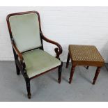 A mahogany framed open armchair with upholstered back and seat, raised on circular supports and