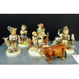 A group of five Goebel's Hummel figures, a Richard Cooper & Co, Sheep dog and pups figure group