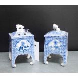 A pair of 19th century Arita porcelain Koros with blue painted landscape scenes, the lids with
