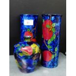 A pair of Cetem ware blue glazed fruit patterned sleeve vases, together with a Rubens ware