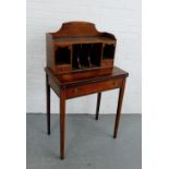 A Lady's mahogany writing desk, the raised back with pigeon holes and two drawers, over a