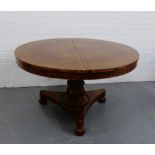 A Victorian mahogany breakfast table, on a carved and fluted column and triform base, with three bun