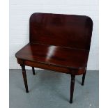 A 19th century mahogany supper or tea table with folding action and raised on turned supports,
