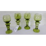 A set of four German moss green glass drinking glasses with etched monogram to bowl, with knop