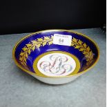 A 19th century Sevres bowl with cobalt blue ground and gilded leaf border with interlaced floral