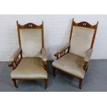 A pair of light oak framed library chairs with pierced and carved top rail over an upholstered back,