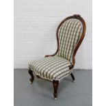 A mahogany framed parlour chair with foliate carved top rail and upholstered back and seat, raised