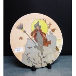 A Victorian porcelain plaque painted with a witches pattern, 28cm diameter