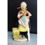 A late 19th century painted bisque figure of a 'Newhaven Fishwife' (with restoration), 22cm high