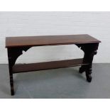 A mahogany side table, the rectangular narrow top with rounded edges and over a Gothic arched