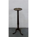 A mahogany torchere stand on reeded column and tripos supports, 110cm high