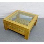 A contemporary light oak coffee table with square glass top, 40 x 86cm