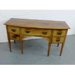 A mahogany sideboard, the rectangular top over an arrangement of five drawers and raised on turned