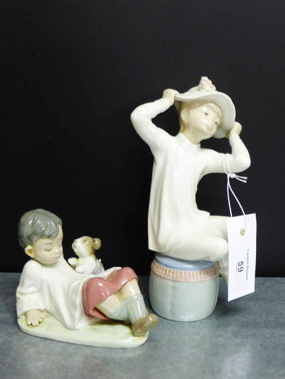 Two Lladro porcelain figures to include a boy with his puppy and another, tallest, (22cm),(2)