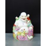 A Famille Rose porcelain figure of Hoti, 22cm high
