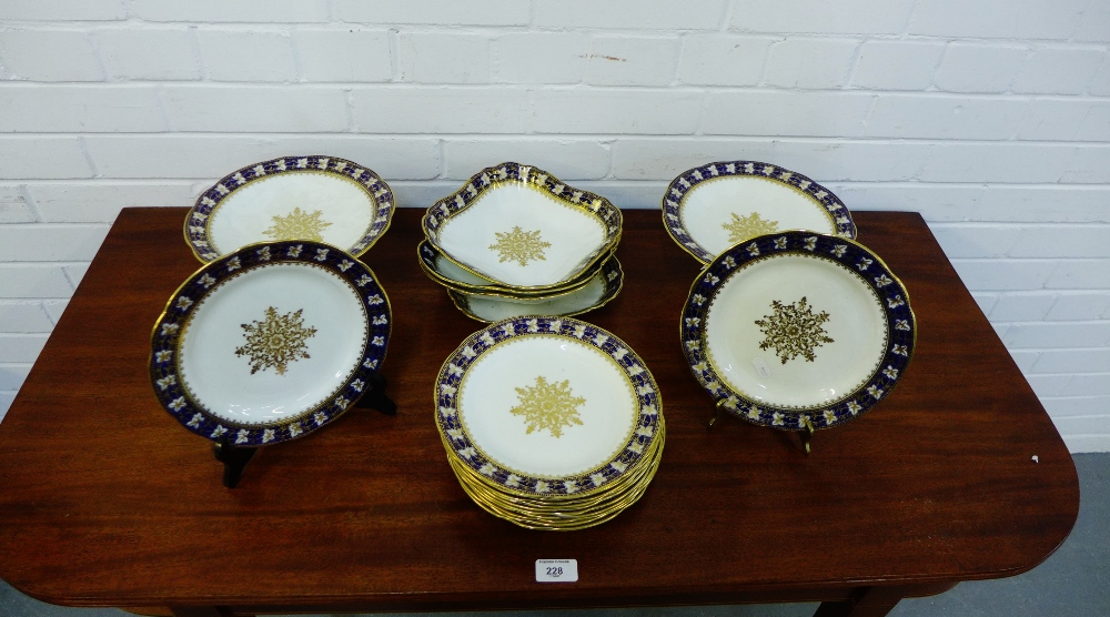 An Aynsley porcelain dessert service with blue and gilded rims comprising twelve plates, two