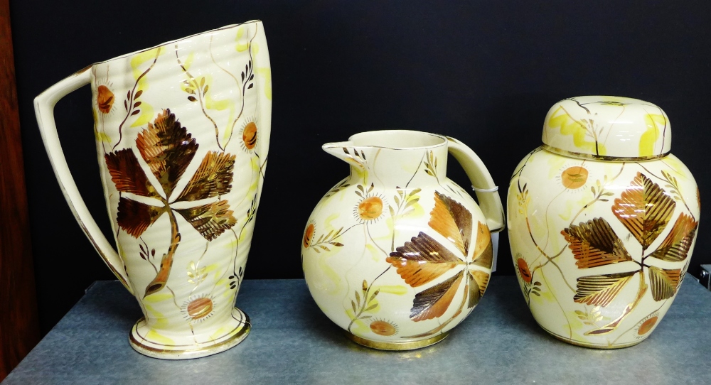 A collection of three Kensington Price 'Gothic' patterned lustre wares to include an Art Deco jug