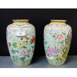 A pair of Japanese high shouldered baluster vases, the pale green ground with birds, flowers and