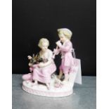 A Coburg porcelain figure group depicting a man, a woman and a ram on an oval base in pink and white