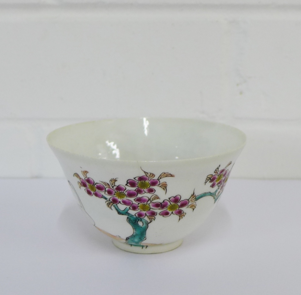 A Japanese porcelain tea bowl painted with prunus and swans pattern, bearing six character mark to