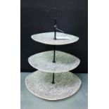 A Mid Winter 'Tonga' patterned three tier black and white glazed cake stand designed by Jessie Tait