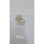 A 9 carat gold Australian Coober Pedy opal set dress ring, with small diamond chips to the shoulders