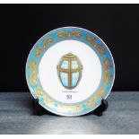 A Russian porcelain plate with heavily gilded pale blue border centred with an imperial Easter egg