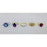 A collection of five 9 carat gold gemset dress rings to include a three stone diamond ring, all UK