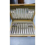 An oak cased canteen containing a suite of Epns fish knives and forks for a twelve place setting