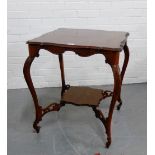 An Edwardian mahogany occasional table, on carved cabriole supports with pointed feet and shelved