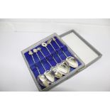 A set of six silver teaspoons each with a different Oriental motif to the terminal, bowls are