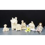 A collection of five Duffy Doll cream glazed figures, together with a porcelain figure of a bell and