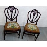 A pair of mahogany side chairs, with heart shaped vertical splat backs over tapestry upholstered