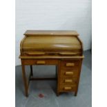 An oak roll top desk, the tambour top over an arrangement of five drawers, 99 x 92cm