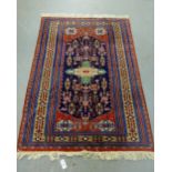 An Eastern rug with central medallion and multiple borders, 180 x 124cm