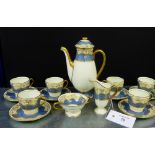 A Royal Doulton demitasse coffee set comprising baluster coffee pot, six cups, six saucers, helmet